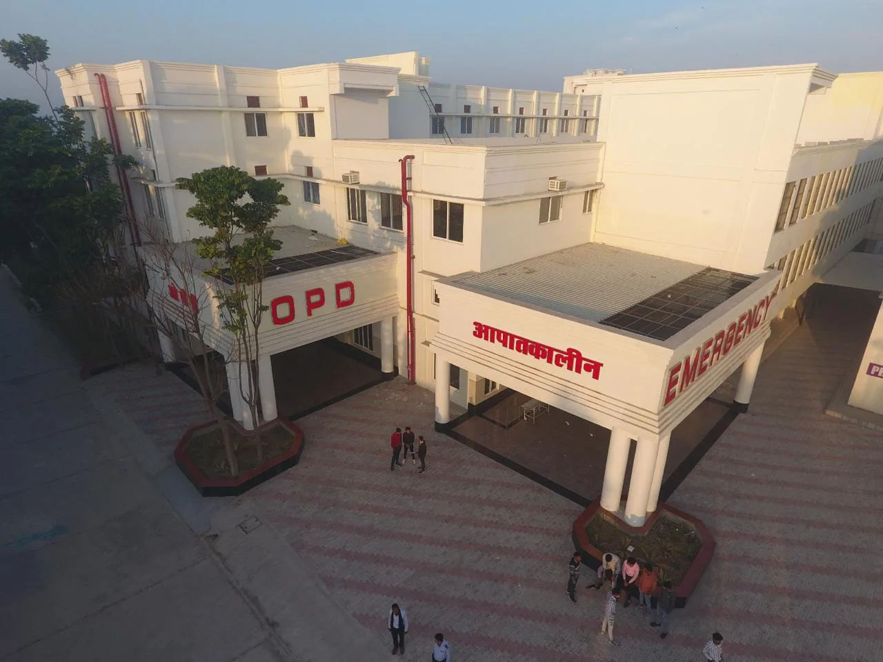 Elevated golden-hour view of the SKS Hospital OPD and Emergency building