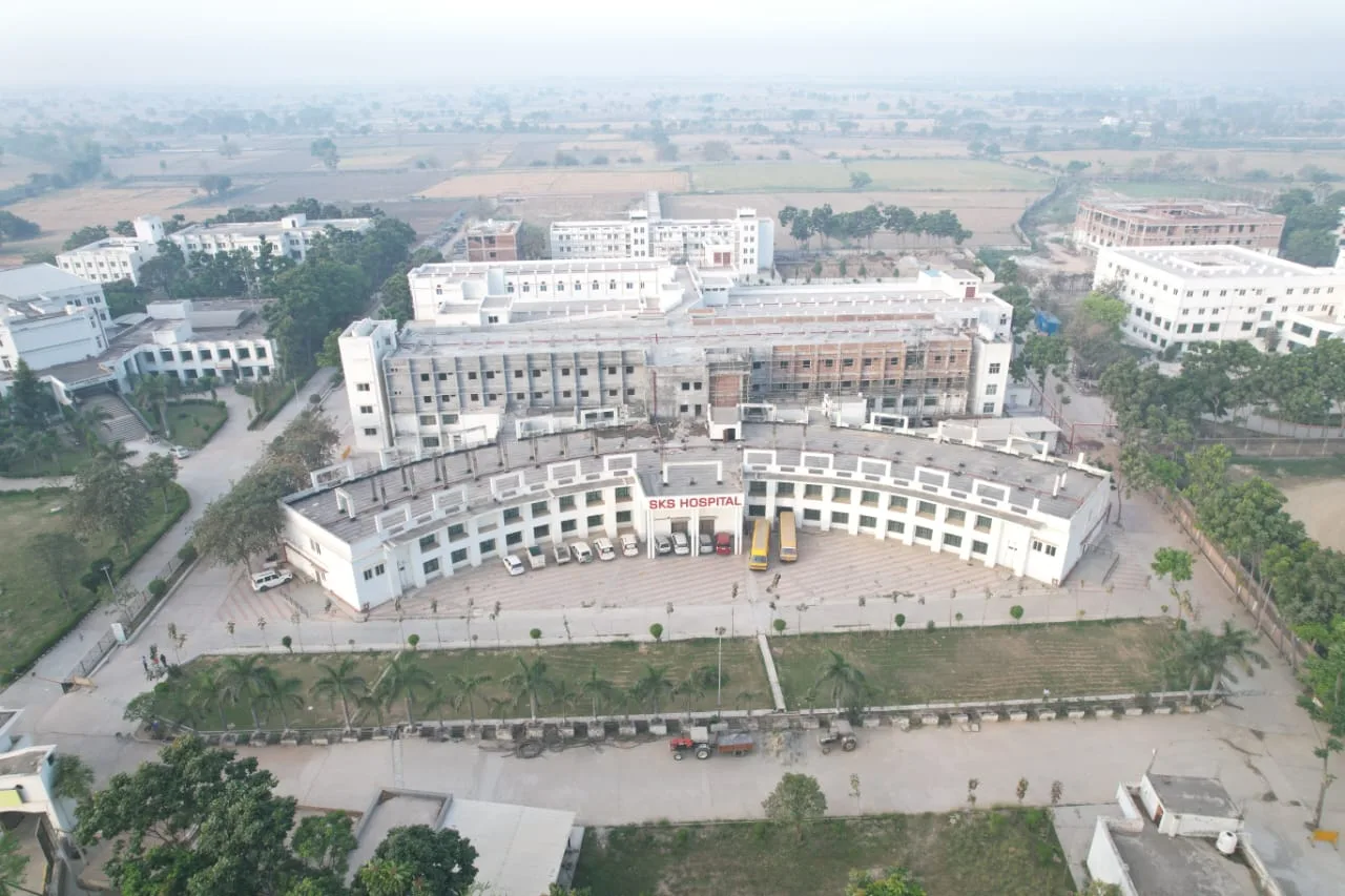 Aerial view of SKS Hospital and surrounding campus on a hazy morning